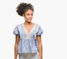 Young afro american woman over isolated background smiling looking side and staring away thinking.