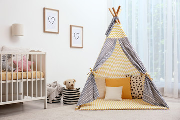 Cozy baby room interior with play tent and toys © New Africa
