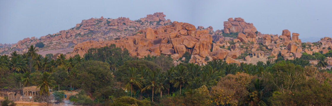 Landscape of rock and coconut trees in Hampi, ancient capital of the Kingdom of Vijayanagara, UNESCO World Heritage Site, Karnataka, India