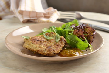 Fried pork chop with fresh herbs and fruit sauce