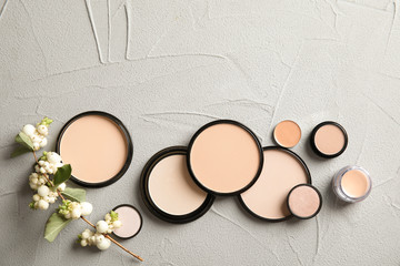 Flat lay composition with various makeup face powders on table. Space for text