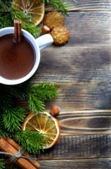 Hot chocolate or cocoa with cinnamon stick in a cup and fir branches. Winter hot drink for cold weather. New year and Christmas concept Top view
