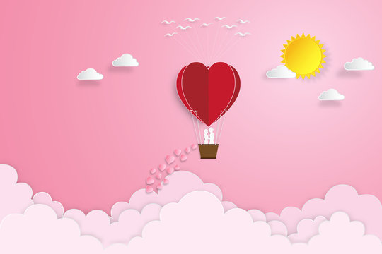 The lover in hot air balloons on pink sky and sunrise background as love , wedding, valentine, design paper art and craft style concept. vector illustration