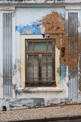 Colorful damaged wall and a window