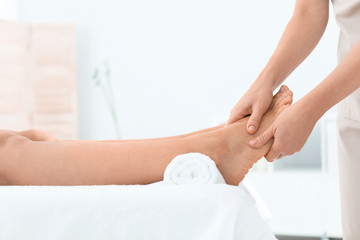 Fototapeta na wymiar Woman receiving foot massage in wellness center, closeup