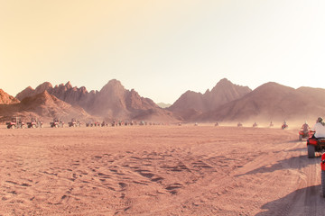 Desert in Egypt. Sharm el Sheikh. Sand and Sand Borkhan. Rock and sunset. Quad Cycle Travel. Excursion with people.