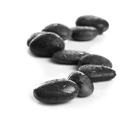 Composition with wet spa stones on white background