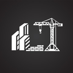 Crane on construction yard on black background icon