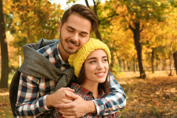 Fototapeta premium Young lovely couple spending time together in park. Autumn walk