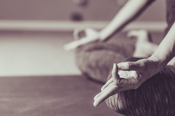 Asian young woman practicing yoga in  gray background.Young people do yoga indoor.