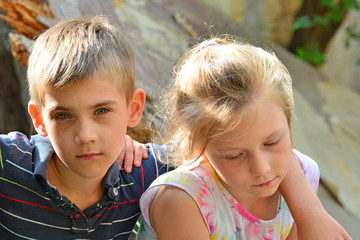 Fototapeta premium Children are near the ruined house, the concept of natural disaster, fire, and devastation.
