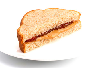 Fototapeta na wymiar A Classic Peanut Butter and Strawberry Jelly Sandwich on Wheat Bread