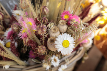 Bouquet of beautiful dried flowers plants - white and pink chrysanthemums, poppies, wheat spikelets...