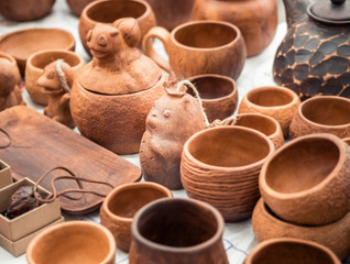 Handmade clay mugs stands on the counter. Eco-friendly cookware. Pottery cups sale
