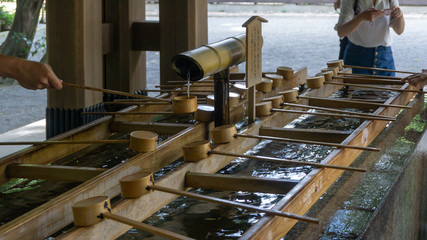 Unidentified people cleaning their hands in Temizuya or Chozuya at Meiji Shrine located in...