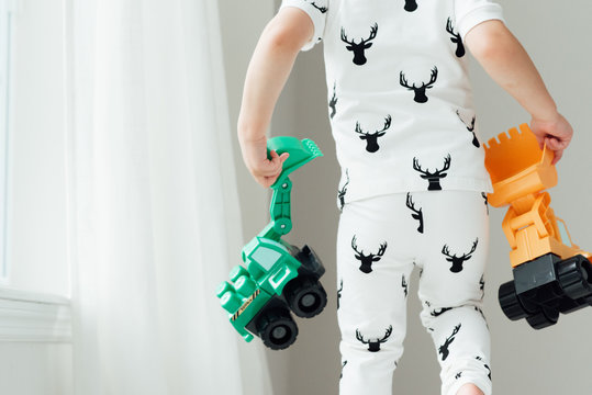 Child holding two toys