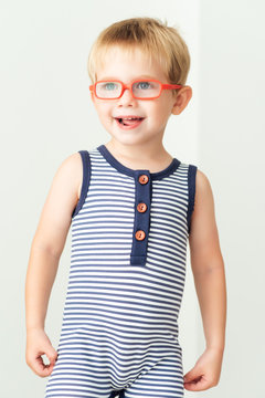 Smiling boy with orange eyeglasses