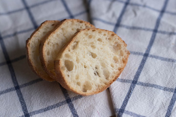 Pieces of bread on the tablecloth.