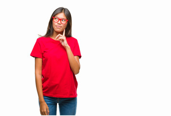 Young asian woman wearing glasses over isolated background with hand on chin thinking about question, pensive expression. Smiling with thoughtful face. Doubt concept.