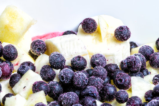 Macro Closeup Of Fruit Salad In Bowl With Frozen Blue Berries, Blueberry, Bilberry, Banana, Apples