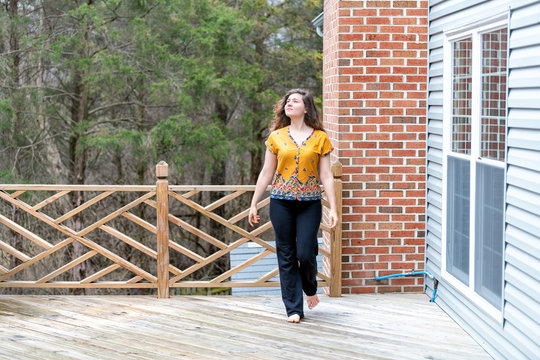 One Young Woman Walking Outside, Outdoors Barefoot On Wooden House, Home Deck, Looking Up, Homeowner At Backyard, Front Yard