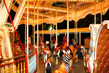 Fototapeta na wymiar an old carousel with horses and other animals in an amusement park. night time.Merry-go-round with horses.