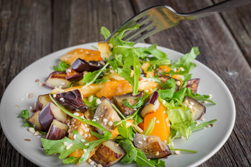 Healthy salad of vegetables - tomatoes, arugula, eggplant