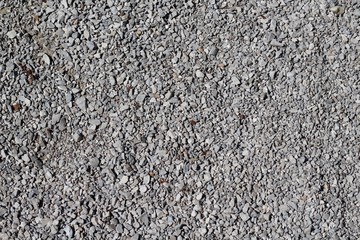 The texture of the pebbles and stones of the gravel.