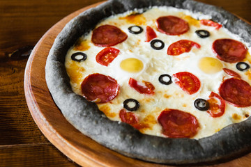 delicious pizza with meat, cheese and mushrooms	