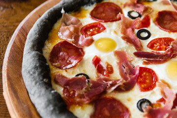 delicious pizza with meat, cheese and mushrooms	