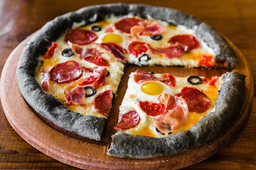 delicious pizza with meat, cheese and mushrooms	