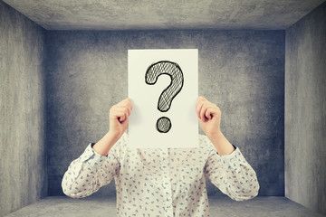 covering her face with a question mark