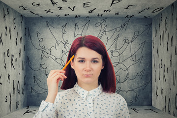 Puzzled businesswoman having questions in front of a a closed room with letters on walls  with a mess in her head  with difficult quest way with obstacles. Self overcome, reaching goals.