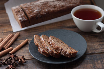 Homemade banana bread with anis star and cinnamon on a dark wooden background