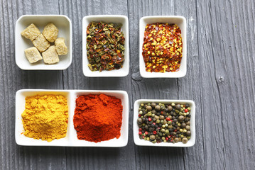 Set of Various spices on black stone table. Top view