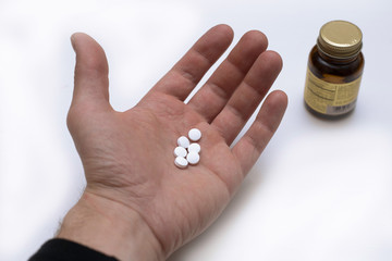 white pills in the hand