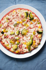 Beetroot base pizza with zucchini, smoked ham, cheese & red onion