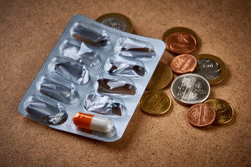 Ending pills and coins, expensive medicament, poverty
