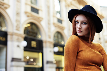 Fototapeta premium Woman pose for a portrait outside of the Galleria Vittorio Emanuele II in Milano Italy