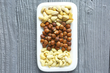 Assortment of nuts on a dark wooden table. View from above