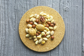 Assortment of nuts on a dark wooden table. View from above