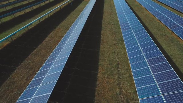 Solar panels with sun light shining. Shot on drone