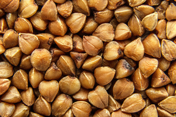 Buckwheat grains background, texture. Healthy food. Top view.