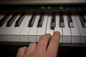 Fototapeta premium Playing on classic electrical piano keyboard