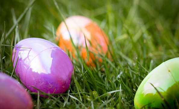 Multi-colored plastic Easter eggs in grass
