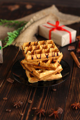 fresh belgian Tasty waffles and gifts on a wooden background. top view.
