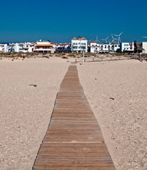 Path of wooden planks next to the sand beach 