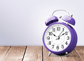 Retro alarm clock on table  background