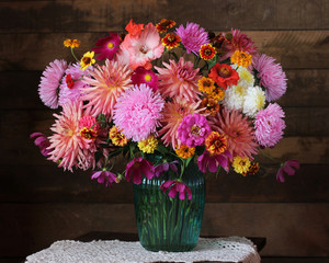 Lush bouquet of autumn garden flowers in a vase.