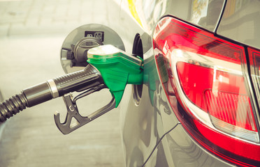 Car refueling at the petrol station. Concept photo for use of fuels (gasoline, diesel, ethanol) in...